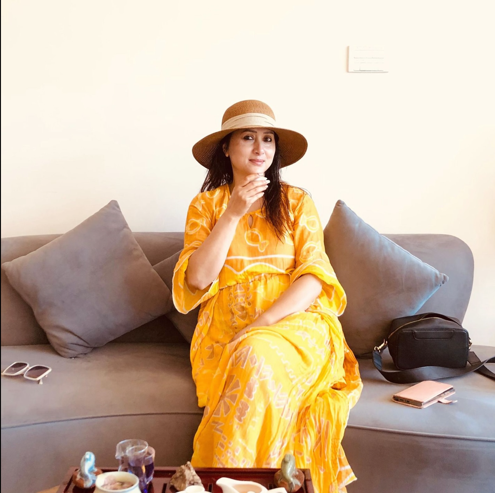 Woman in yellow dress enjoying tea
