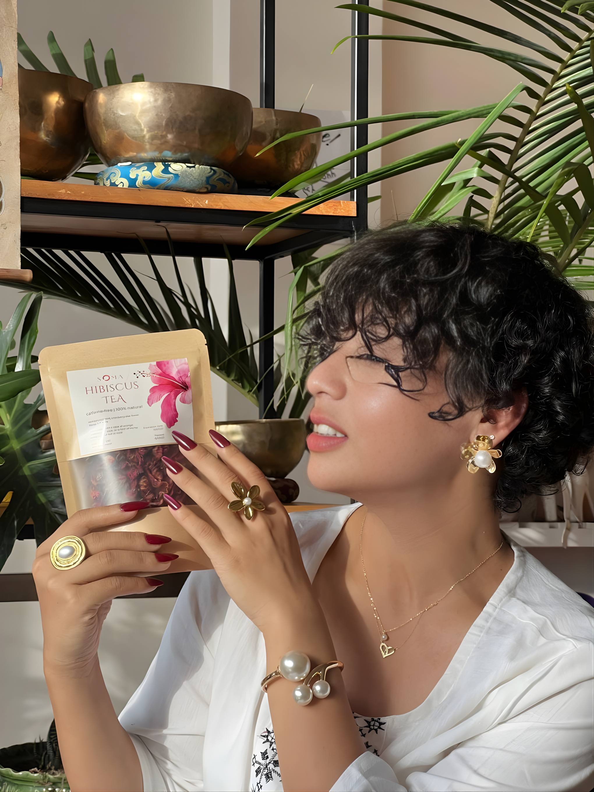 Woman in tea shop holding artisanal product